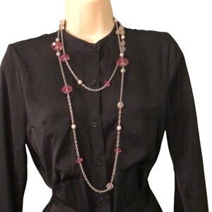 Long silver tone necklace with pink beads